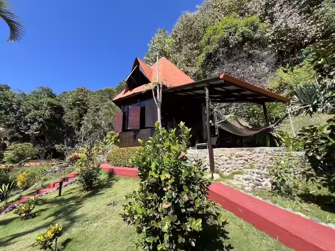 Bungalow with a hammock terrace surrounded by gardens at Hotel El Jardín
