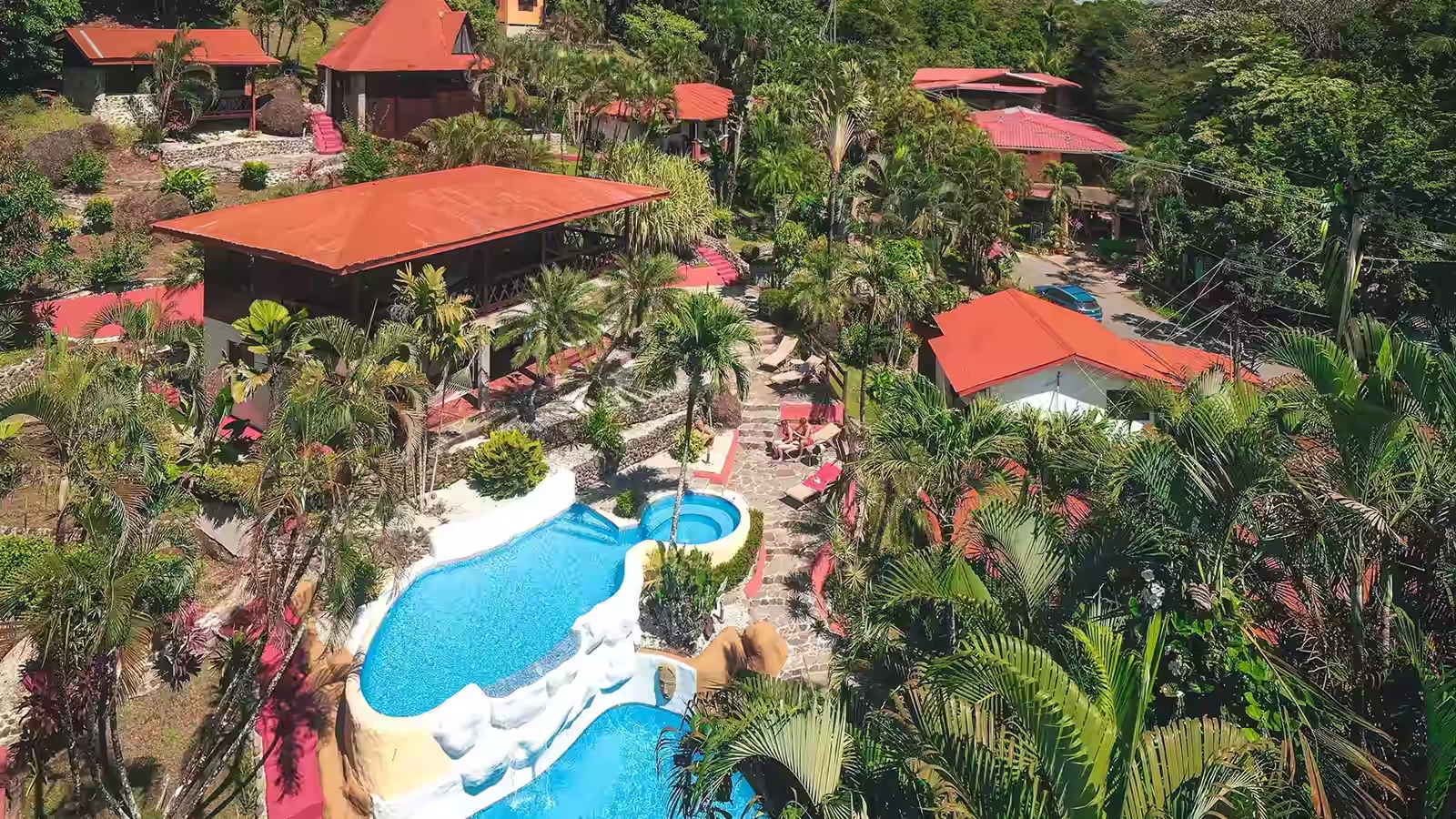 Aerial view of the pools, tropical gardens and guest buildings at Hotel El Jardín in Montezuma