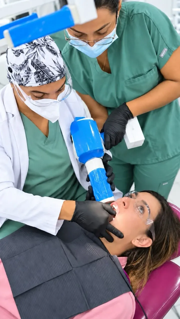 Two Esthetic Dent doctors attending a patient in the treatment chair