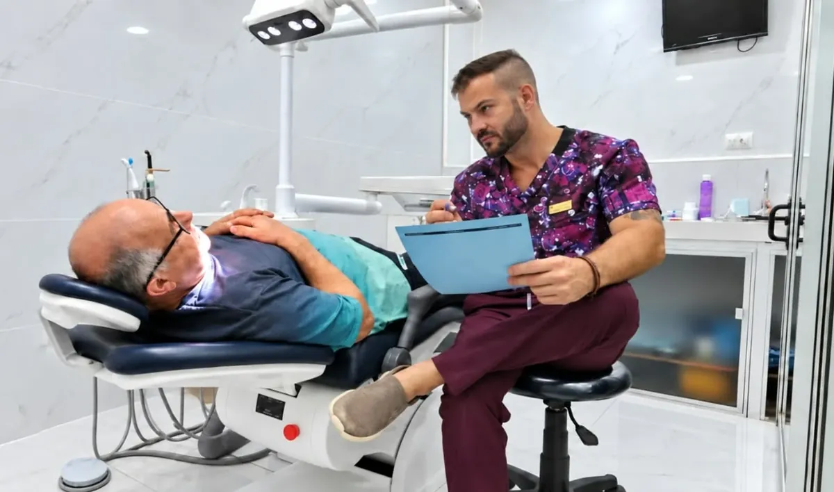 An Esthetic Dent dentist reviewing a patient's treatment records chairside in Costa Rica