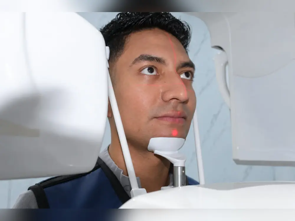 Patient during a digital scan before crown design at Esthetic Dent